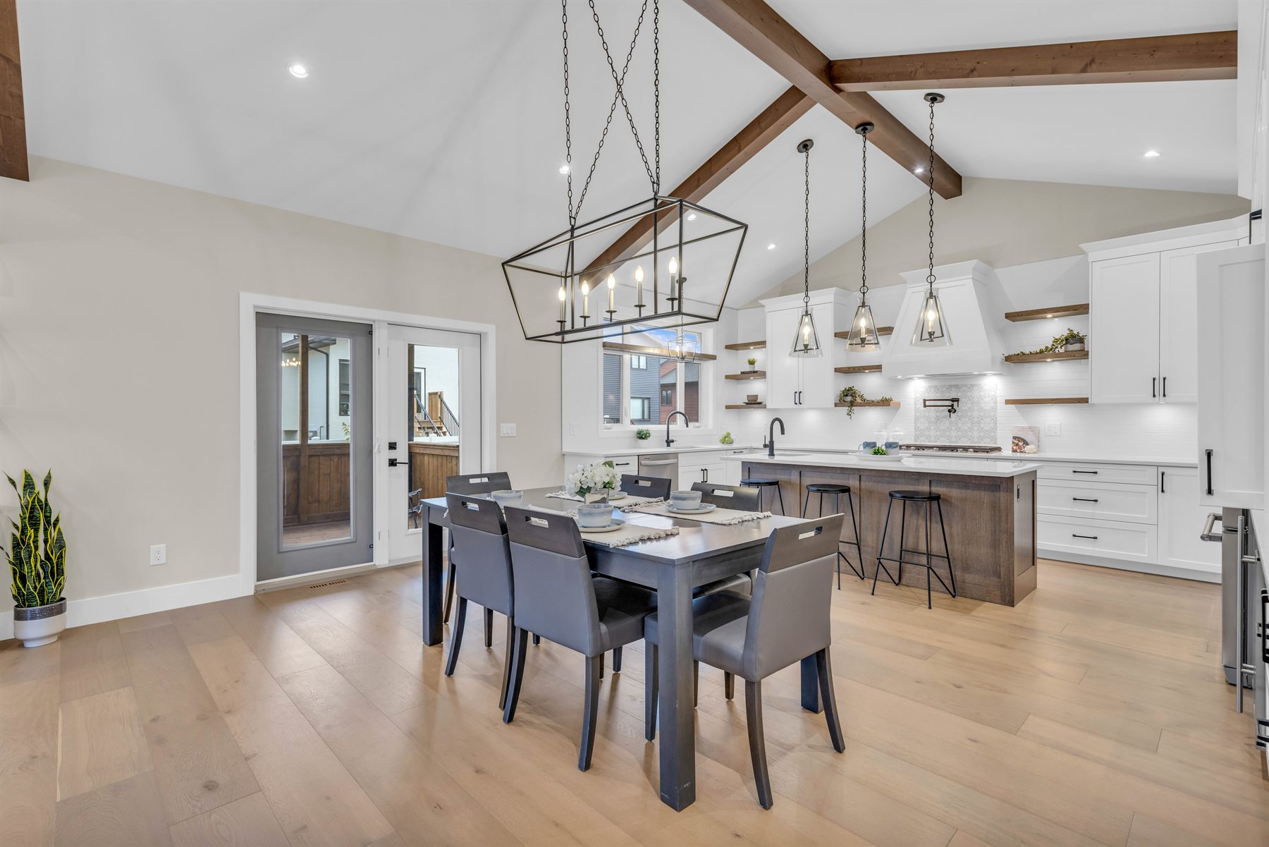 Bright kitchen and dining room with exposed timber beams, photographed by YXE Home Photos